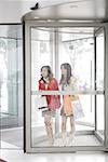 Young women at the doorway of shopping mall