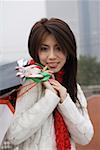 Young woman holding shopping bag smiling, portrait