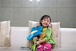 Portrait of girl playing with flower toy