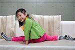 Girl sitting on sofa, smiling