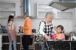 Family preparing food in kitchen