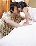 Father and daughter playing in bedroom