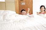 Brother and sister playing in bedroom