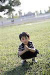 Portrait of a boy crouching