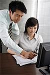 Businessman and a businesswoman discussing in office