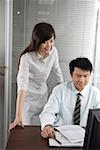 Businessman and a businesswoman discussing in office