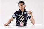 Close-up of a young man sitting with cake