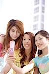 Young women with mobile phone, smiling