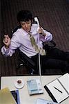 Office young man phoning at desk