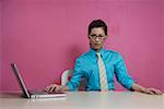 Young woman using laptop, portrait