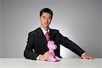 Young businessman holding toy