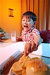 Boy drinking milk and eating cookies