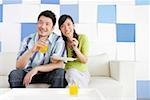 Young couple sitting with glass of juice