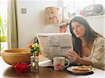 Portrait of Woman Looking Through Newspaper Classifieds