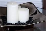 Close-up of candles and pebbles in a tray