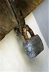 Close-up of a padlock on a wooden door