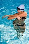 Young woman standing in a swimming pool