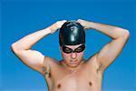 Close-up of a young man wearing a swimming cap