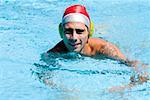 Portrait of a mid adult man swimming in a swimming pool