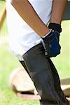 Low section view of a person wearing a riding boot