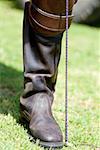 Close-up of a person's leg wearing a riding boot