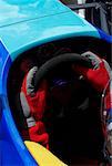High angle view of a racecar driver's hands holding steering wheel of a racecar