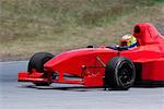 Person driving a formula one racing car on a motor racing track