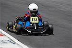 Person go-carting on a motor racing track