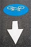 High angle view of an arrow sign at a bicycle lane