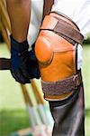 Close-up of a polo player tying riding boots