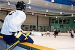 Side profile of an ice hockey player watching ice hockey