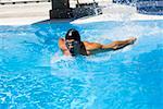 Young man swimming the butterfly stroke in a swimming pool