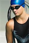 Close-up of a teenage girl wearing a swimming cap and swimming goggles
