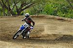 Motocross rider leaning into a turn