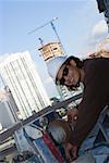 Side profile of a male construction worker working at a construction site