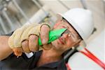 Close-up of a male construction worker holding a cutting tool