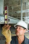Close-up of a male construction worker using a spirit level