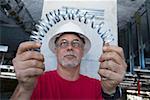 Close-up of a male construction worker folding a metal spring