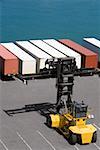 High angle view of a forklift with cargo containers at a commercial dock