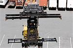 High angle view of a forklift with cargo containers in the background