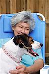 Senior woman with a dog and smiling