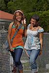 Two young women walking and smiling