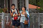 Teenage boy and his sister walking and smiling