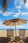 Two outdoor chairs and a beach umbrella on the beach, Ocean Park El Condado, San Juan, Puerto Rico