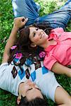 High angle view of a young couple lying in a park