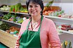 Portrait of a mature woman standing in a grocery store and smiling