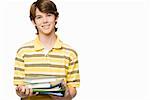 Portrait of a teenage boy holding books and ring binders