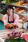 Portrait of a mature woman holding fruits and smiling