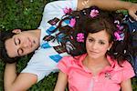 High angle view of a young couple lying in a park