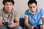 Two young men playing video game